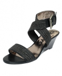 Fabric and leather intertwine to create the stylish Erica sandal by DKNYC. A big ankle buckle adds a dramatic flair.