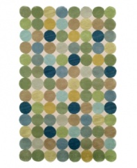 A series of colorful circles stand side-by-side to create a serene ocean of washed out shades of green, blue and gold over a neutral ground. The rug's unique edge, comprised of the collective curves of the outer circles, brings a modern touch to any room in your home. Hand-tufted with an intimate blend of synthetic fibers for a soft, yet durable construction.