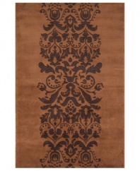 Play with patterns! Wake up your decor with Momeni's irresistibly contemporary rug. A vintage-inspired motif of plumes and blooms adorns this brown wool rug, hand-tufted for texture and superior softness.