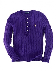 A traditional cable-knit sweater takes a feminine turn with delicate ruffle trim along the buttoned front.