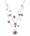 Sweetly chic. Betsey Johnson's ultra-feminine illusion necklace combines petite heart and flower charms in a three-tier design. Crafted in antique gold-plated mixed metal with pink, purple and blue crystals and glass pearl accents. Approximate length: 16 inches + 3-inch extender. Approximate drop: 4 inches.