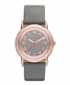 Tastefully trendy. The perfect amount of shimmer and shine accents this watch by Marc by Marc Jacobs. Metallic gray leather strap and round rose-gold ion-plated stainless steel case. Gray mirrored dial features rose-gold tone logo letters at markers and three hands. Quartz movement. Water resistant to 50 meters. Two-year limited warranty.