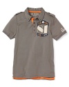 GUESS updates the traditional polo with cool military details and patchwork appliqué accents.