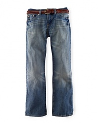 A slim-fitting jean is rendered in a lightly faded wash for a rugged timeworn character.