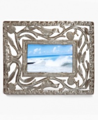 Change the landscape with the eco-friendly Open Leaf picture frame by Mirtha Balan. Recycled steel hand-cut and hammered with precise and beautiful detail surrounds images of your favorite people and places like a lush Haitian canopy.