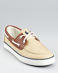 With a khaki canvas upper and leather trim, this handsome boat shoe embodies Ralph Lauren's heritage style.