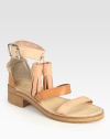 Oversized tassels and modern colorblocking rejuvenate this leather gladiator with a wide, adjustable ankle strap. Stacked heel, 1 (25mm)Leather upperLeather lining and solePadded insoleMade in ItalyOUR FIT MODEL RECOMMENDS ordering true whole size; ½ sizes should order the next whole size down. 