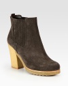 Suede ankle boot with a crepe sole and elastic gores. Rubber heel, 4 (100mm)Rubber platform, ½ (15mm)Compares to a 3½ heel (90mm)Suede upperBack pull-tab and side elastic goresLeather liningRubber trek solePadded insoleImported