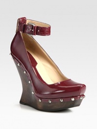A sculptural wooden heel lifts this studded patent leather design, topped with a trendy-worthy ankle strap. Wooden wedge, 5 (125mm)Wooden platform, 1 (25mm)Compares to a 4 heel (100mm)Patent leather upper with metal studsAdjustable ankle strapLeather liningRubber solePadded insoleImportedOUR FIT MODEL RECOMMENDS ordering one half size up as this style runs small. 