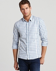 Furnished with front and back darts for a slim, modern fit, this smooth button-down cuts a cool figure wherever you choose to wear it.