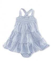 A charming smocked sundress is rendered in striped cotton jersey and finished with a ruffled hem.