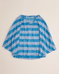 Her look takes flight with Aqua's cool slub poncho, rendered wide stripes and raglan sleeves for a classic silhouette.