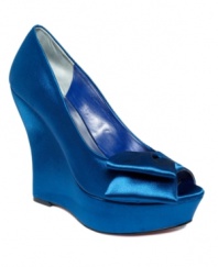 Fabulous enough for a princess. The Shelley wedges by Paris Hilton shine in satin with a darling bow at the peep toe.