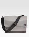 A stylish twill messenger bag for your every file and gadget.Flap-top snap closureAdjustable shoulder strapExterior slit pocketInterior laptop compartment with snap closureCotton14½W X 11H X 5½DImported