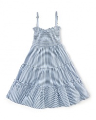 A stylish striped jersey dress is updated with smocked detailing and a pretty flared silhouette.