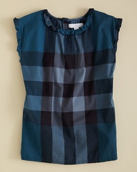 Burberry's sleeveless blouse updates a classic look with ruffle trim and bow accents.