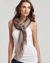 A large dyed woven scarf in a lightweight fabric with self fringe edges.