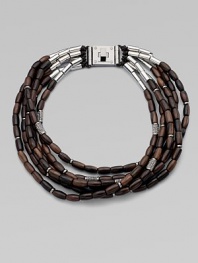 Beautifully textured, wooden beads with a sprinkle of rhinestone encrusted beads on leather cords in a chunky multi-row design. WoodLeatherBrassGlass stonesLength, about 20Logo accented turn-lock closureImported 