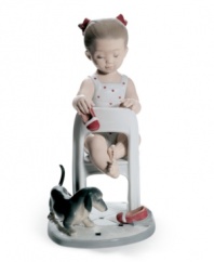 Puppy love. A little girl plays footsie with a furry friend, kicking off her red slippers in a cute Lladro figurine for parents and pet owners.