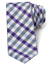 A nostalgic multi-tone check pattern features a narrower width for a modern silhouette and is crafted in plush silk.