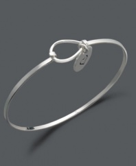 Get caught up in the game of love. This subtly stylish bangle features an engraved heart charm with the word love engraved on the flip side. Crafted in sterling silver. Approximate diameter: 2-3/10 inches.