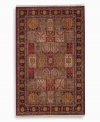 A striking example of classic Bakhtiyari designs, this rug features organic motifs in a panel design of reds, greens and golds, finished with a rosette border. A special antique wash enhances and harmonizes the burnished colors to create a rich vintage finish. Woven in the USA of luxuriously soft premium worsted New Zealand wool.